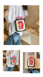 Detail of plush crossbody bag featuring rich embroidery, wavy handle and plaid strap