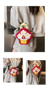 Detail of red plush crossbody bag with floral embroidery and unique yellow handles