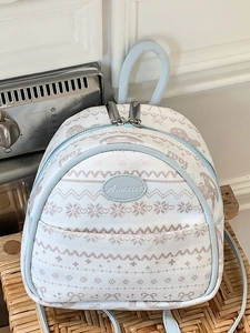 Blue and white patterned mini backpack for women featuring snowflake and heart prints