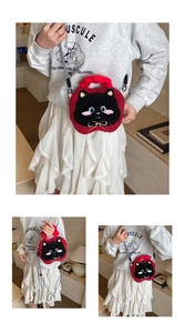 Detail of cute red plush cat crossbody bag showing embroidery and woven shoulder strap