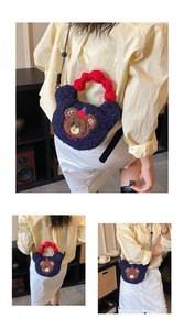 Detail of blue plush bear crossbody bag with a red textured handle and embroidery