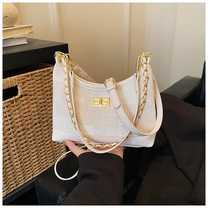 Detail view of the retro canvas tote with chain strap and golden buckle closure