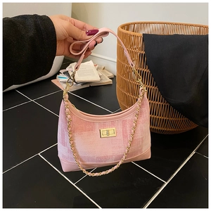 Detail of pink woven texture shoulder bag with gold chain strap and twist lock closure