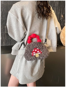 Close-up of cute plush mushroom crossbody bag with textured fabric and woven strap