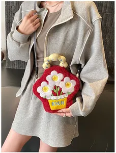 Detailed view of red plush crossbody bag with 3D white flowers and blue RICH embroidery
