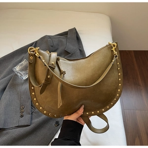 Detailed view of olive green retro shoulder bag with gold rivet accents and hardware hooks