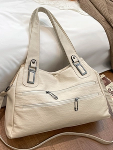 Retro cream leather tote bag with multiple zip pockets and adjustable shoulder strap
