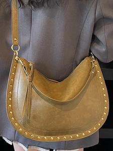 Retro mustard suede half-moon crossbody bag with gold rivets and stylish tassel detail