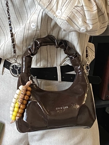 Dark brown leather pleated handbag with silver chain and bead charm for office wear