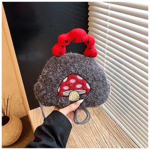 Detail of grey plush mushroom bag with red embroidery and wave-shaped handle