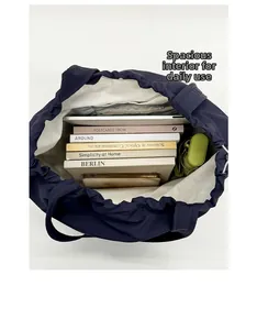 Macro view of blue tote bag interior showing ample storage for books and laptop