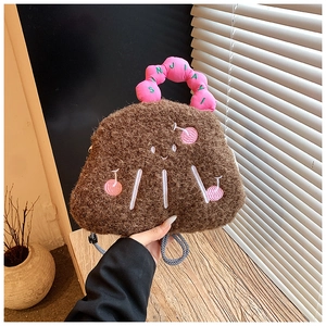 Close-up of plush cherry embroidered bag with pink ruched handle and adjustable rope