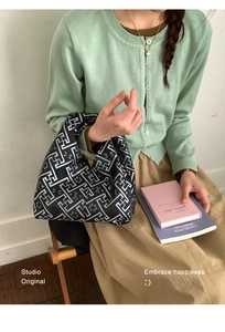 Detailed view of the black and white geometric pattern on a Chinese style canvas wrist bag