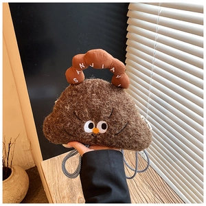 Detail shot of brown plush cartoon crossbody bag with embroidered eyes and nylon handle