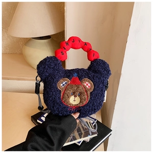 Detailed shot of cartoon bear plush crossbody bag with red soft handle and embroidery