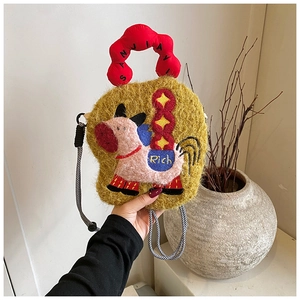 Detail of plush yellow crossbody bag with pink pony embroidery and red bubble handle
