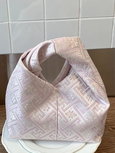 Ethnic style pink and white knot bag with traditional jacquard floral pattern