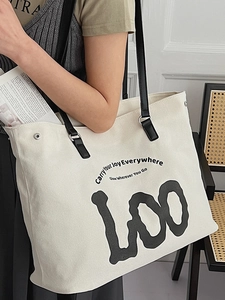 Large white canvas tote bag with black straps featuring stylish graphic print and lettering