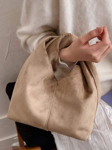 Minimalist khaki pleated cloud handbag shown on model for casual daily commuting
