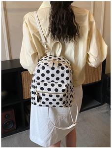 Polka dot backpack back view showing the main compartment and side pockets in daily use