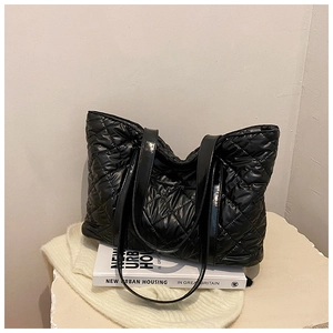 Gros plan détaillé du motif losange noir matelassé sur un grand sac cabas bouffant
