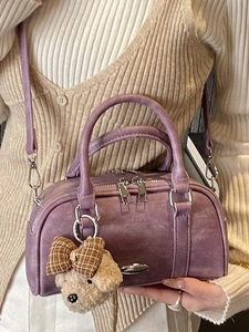 Purple suede Boston handbag with a cute teddy bear charm and adjustable shoulder strap