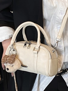 Cream white Boston handbag with silver hardware and a cute dog plush charm detail
