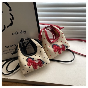 Detail view of mini canvas crossbody bags featuring polka dots and embroidered horse motif