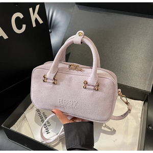 Detailed view of lilac matte leather handbag with gold hardware and embossed logo