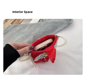Internal view of the red crochet phone bag with pearl strap showing storage space