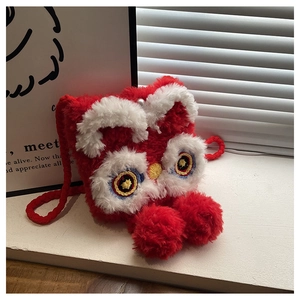 Detail of red plush lion dance crossbody bag with intricate embroidery and soft textures