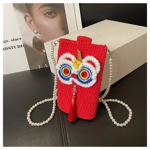 Detail of red crochet lion dance phone bag with pearl chain and festive tassels