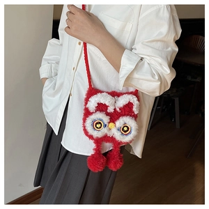 Detail of hand-crocheted lion dance crossbody bag with 3D embroidery and red plush charms