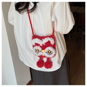 Close-up of cute red plush lion dance crossbody bag with colorful eye details and soft texture