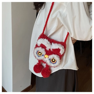 Detail of red plush lion dance crossbody bag featuring pearl clasp and embroidery