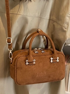 Brown suede minimalist crossbody handbag with top handles and golden hardware details