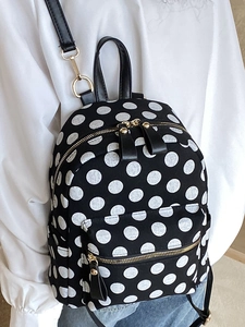 Japanese style black polka dot backpack with gold zippers for school and travel