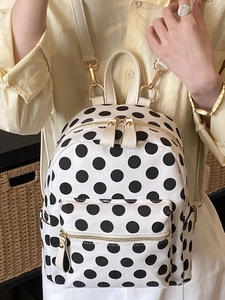 Classic black and white polka dot backpack with gold zippers for daily travel and school