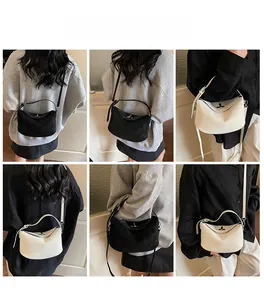 Detail shots of black suede and off-white leather luxury crossbody pillow bag with metal clasp