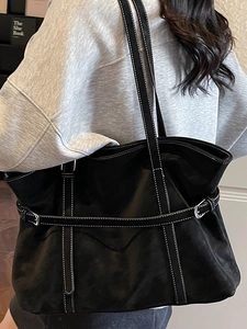 Classic black leather tote bag with white contrast stitching and silver metal buckle