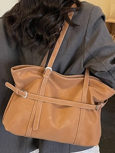 Vintage brown leather tote bag with decorative stitching and silver buckle straps for women