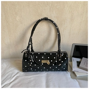 Minimalist black polka dot shoulder bag with silver heart pendant and metal brand plate