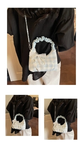Detail of blue checkerboard bag with lace bow, pearl chain and cute bear embroidery