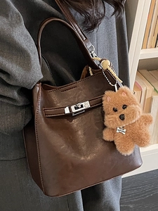 Retro brown textured handbag with silver buckle and plush dog charm for women