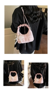 Detailed view of pink plaid handbag featuring large pearl lace bow and cute bear pattern