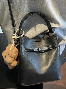 Vintage black pebble leather bucket bag with rotating lock and cute bear charm pendant