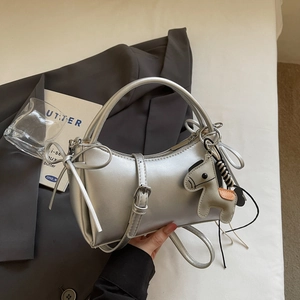 Sac bandoulière argenté brillant avec détail de nœud et breloque cheval de style chic