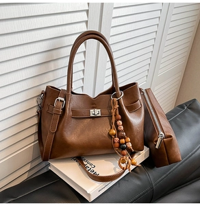 Brown vintage leather handbag set with bohemian wooden beads and silver twist lock detail