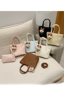 Detailed view of fashionable leather tote bag set in six colors with bear charm
