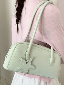 Minimalist mint green leather bowling bag for women with a star charm and long shoulder strap
